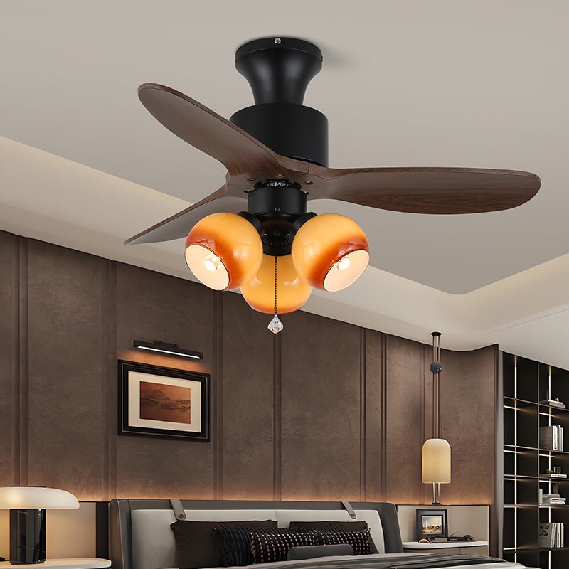 Vista ravvicinata del paralume in vetro e delle pale effetto legno del ventilatore da soffitto Veloria con luce