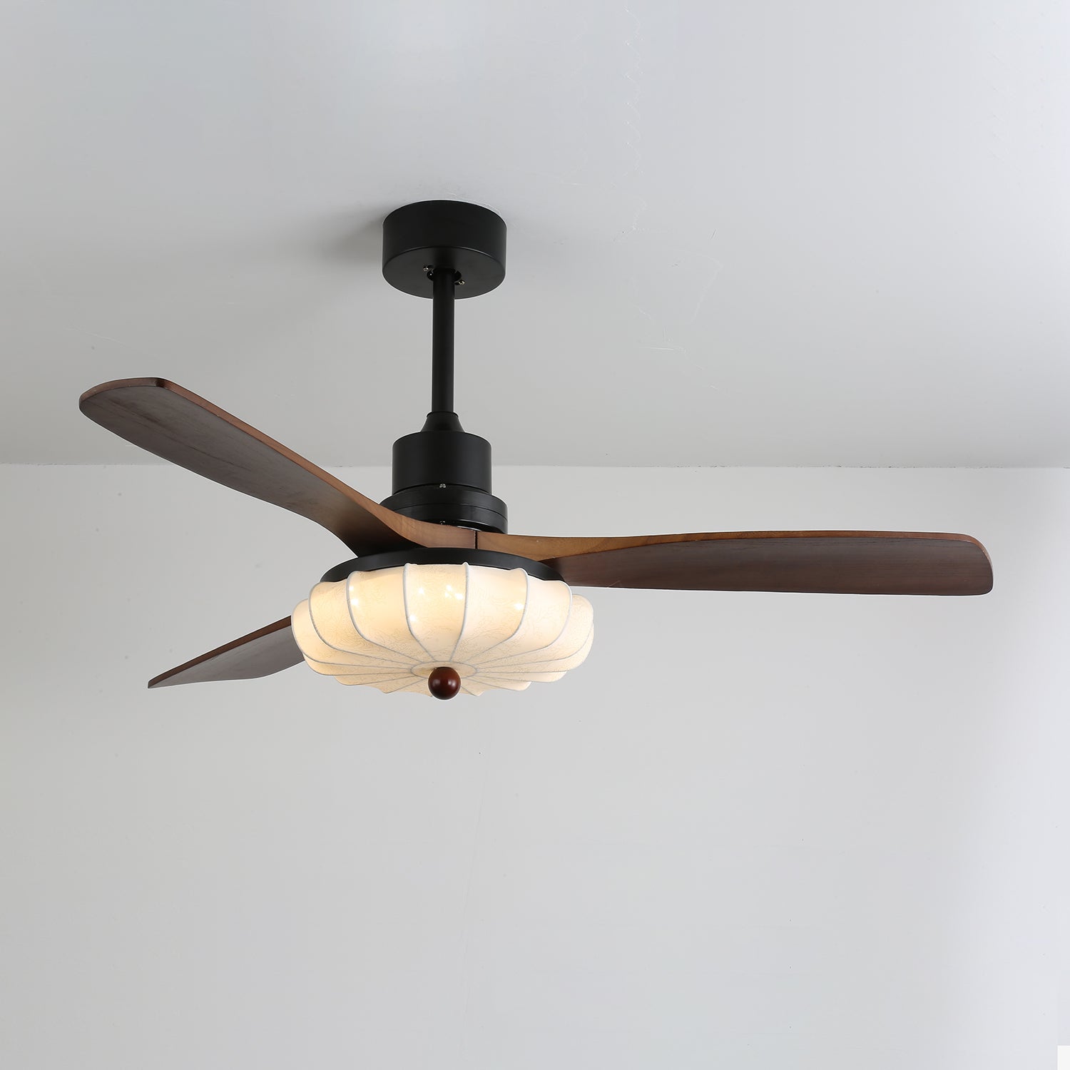 Primo piano del ventilatore da soffitto Ventra che mostra la struttura in metallo nero e le pale in legno
